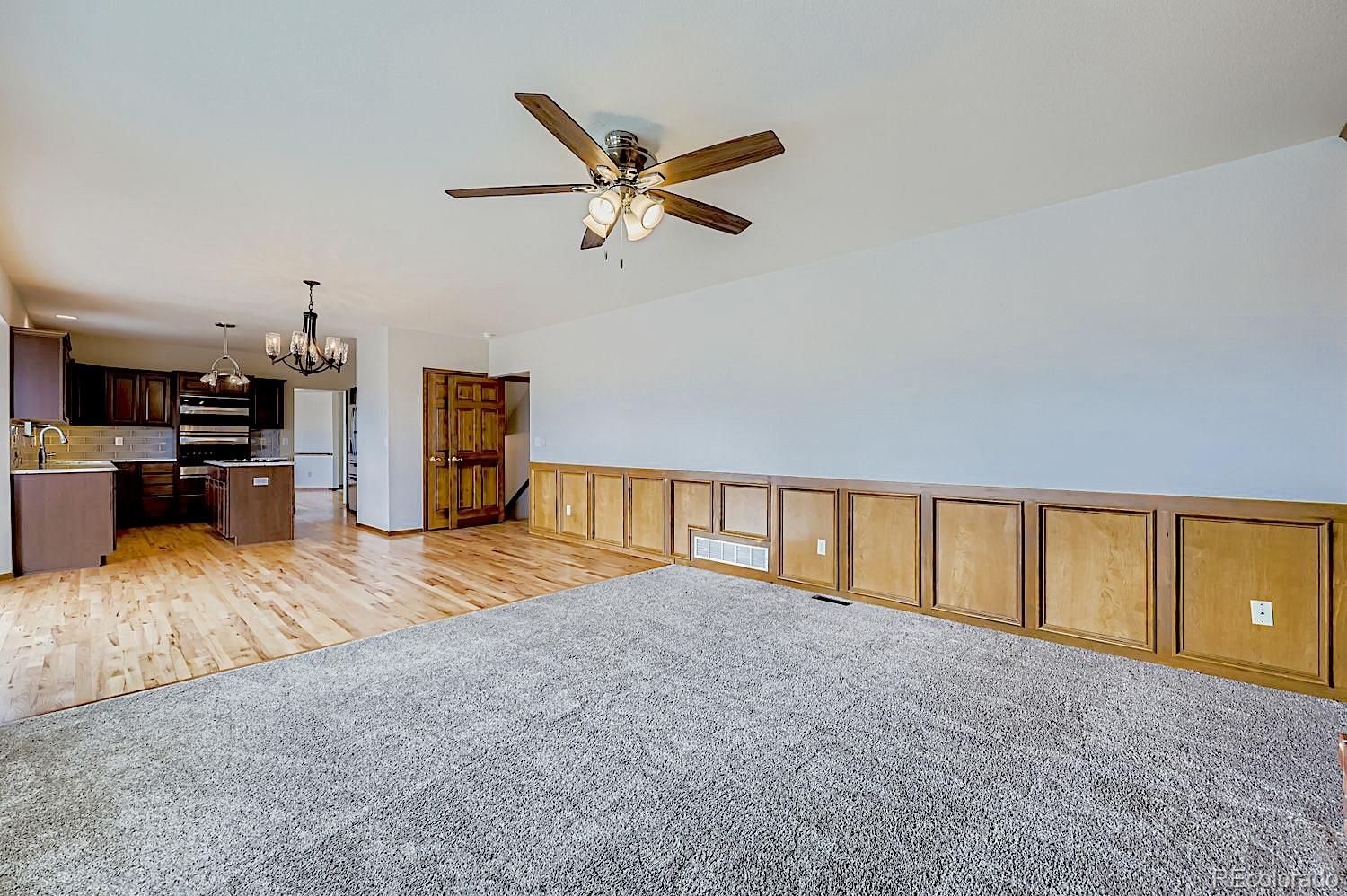 5825 Wilson Road Colorado Springs, CO 80919 - Photo 16 of 50 a view of livingroom with kitchen furniture and a ceiling fan