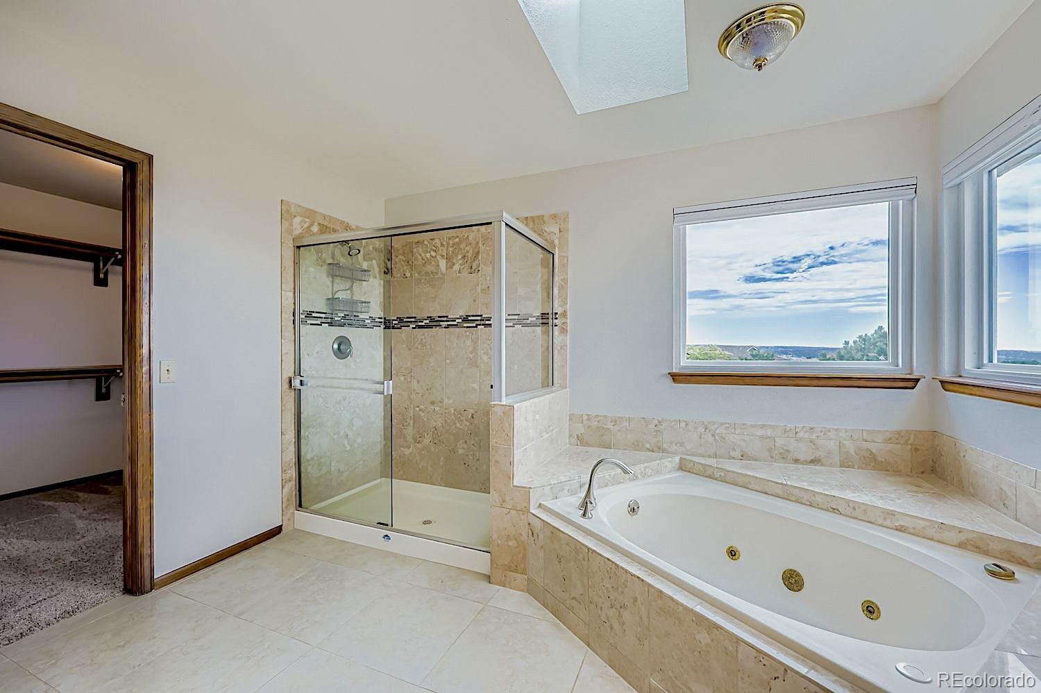 5825 Wilson Road Colorado Springs, CO 80919 - Photo 23 of 50 a bathroom with a tub a sink and a shower