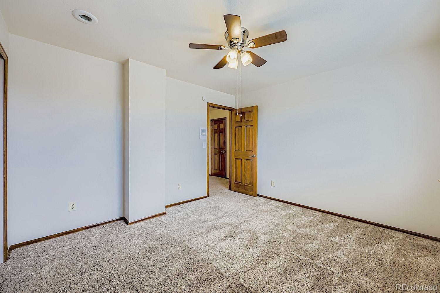 5825 Wilson Road Colorado Springs, CO 80919 - Photo 32 of 50 an empty room with a ceiling fan and a window