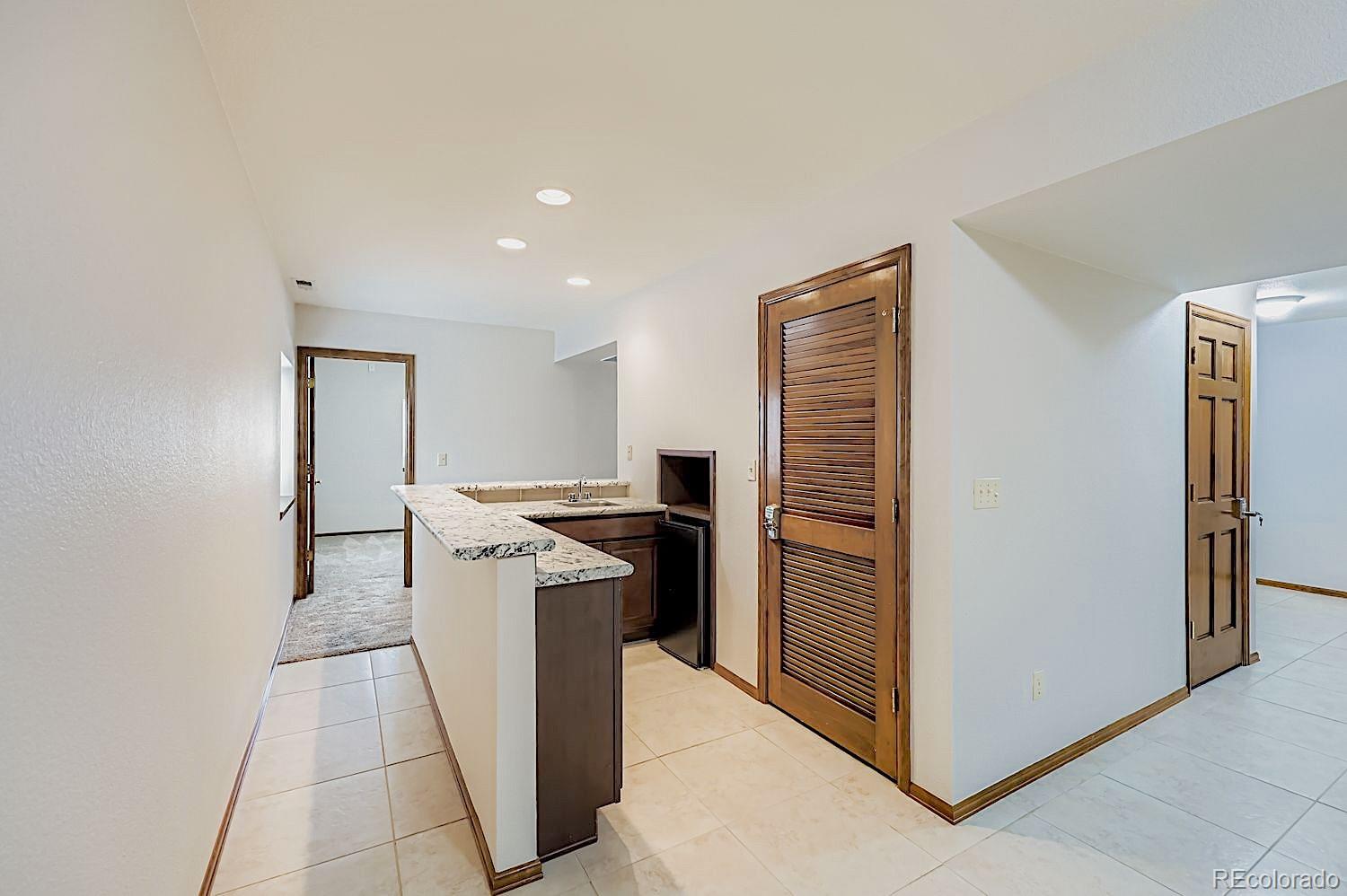 5825 Wilson Road Colorado Springs, CO 80919 - Photo 41 of 50 a kitchen with a refrigerator and a stove top oven