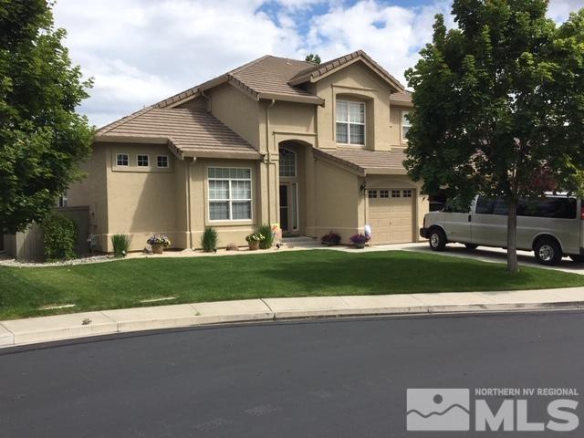 9970 Moccasin Court Reno, NV 89521 - Photo 1 of 6 a front view of a house with a garden and plants