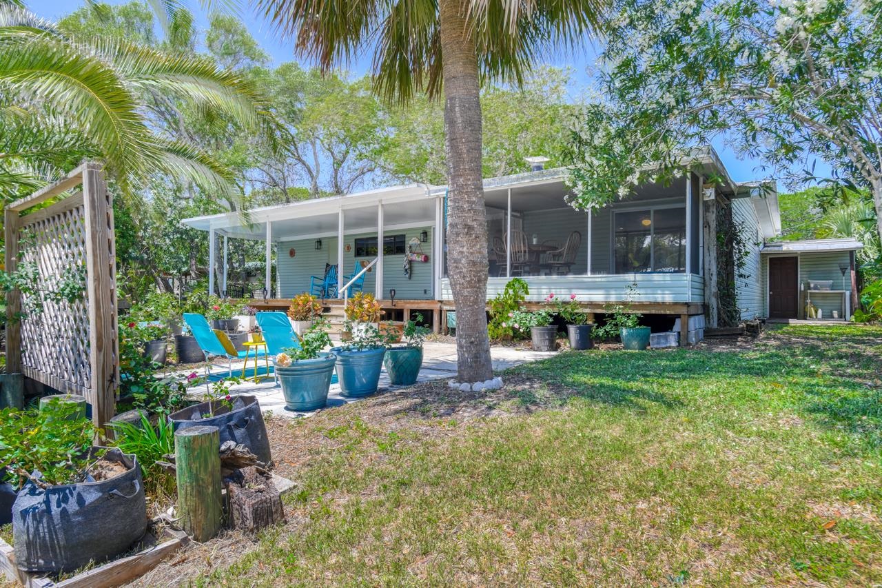 231 Hildago Road St. Augustine, FL 32080 - Photo 12 of 49 a view of house with outdoor seating and garden
