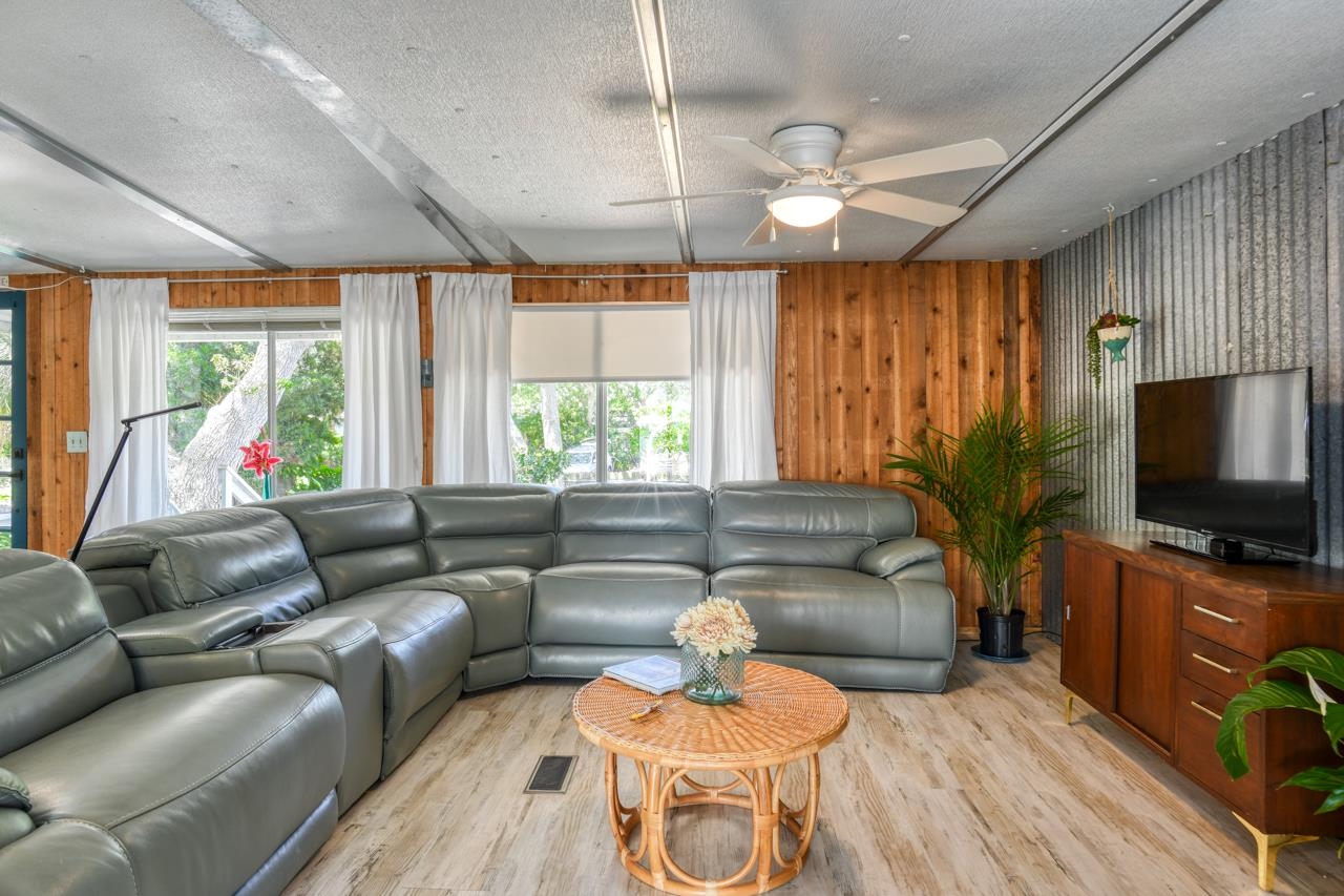 231 Hildago Road St. Augustine, FL 32080 - Photo 23 of 49 a living room with furniture a flat screen tv and a large window
