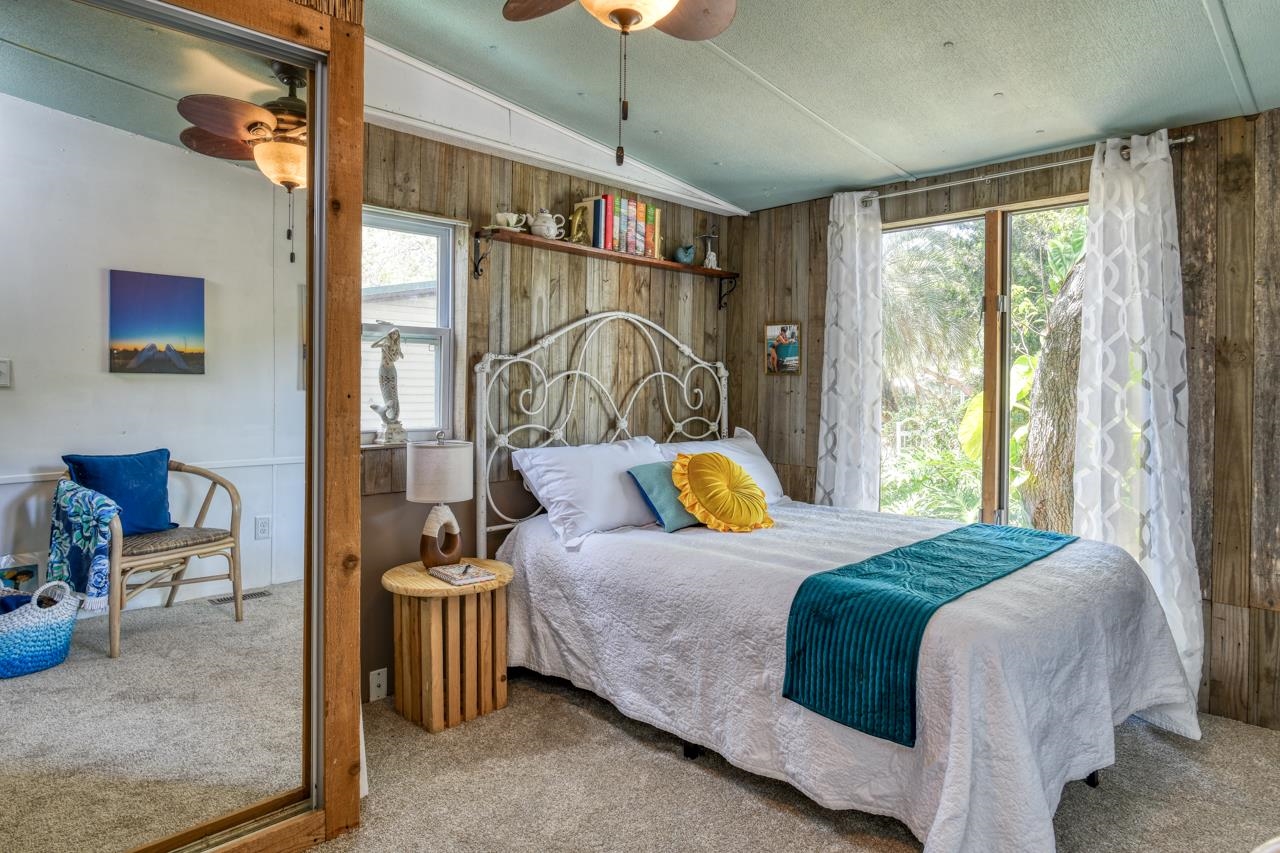 231 Hildago Road St. Augustine, FL 32080 - Photo 35 of 49 a bedroom with a bed and a chandelier