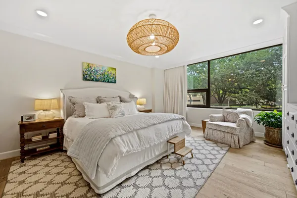a bedroom with a bed and a large window