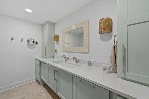 a bathroom with a double vanity sink and a mirror