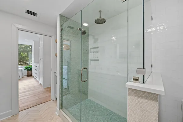a bathroom with a shower and a sink