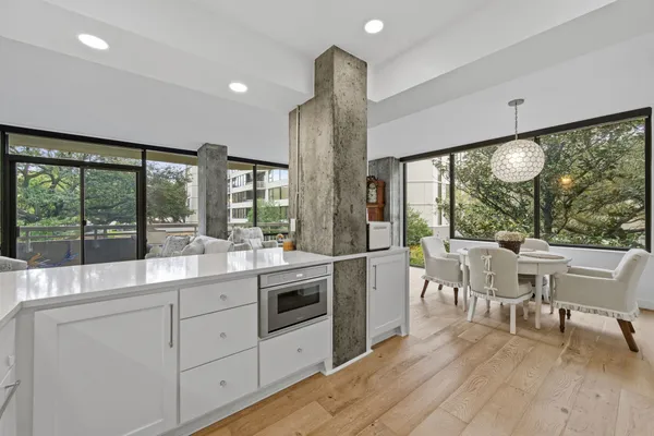 a kitchen with a table chairs and wooden floor