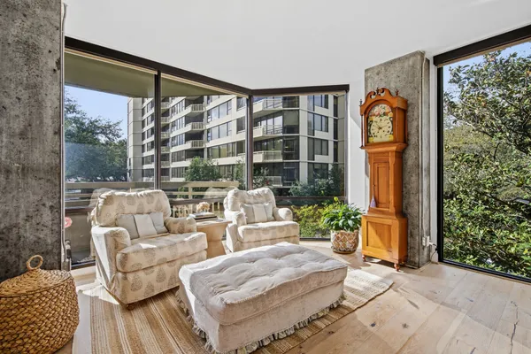 a living room with patio furniture and a potted plant