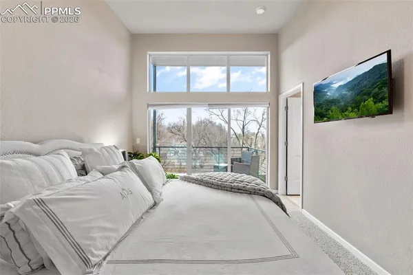 a bedroom with bed and a potted plant