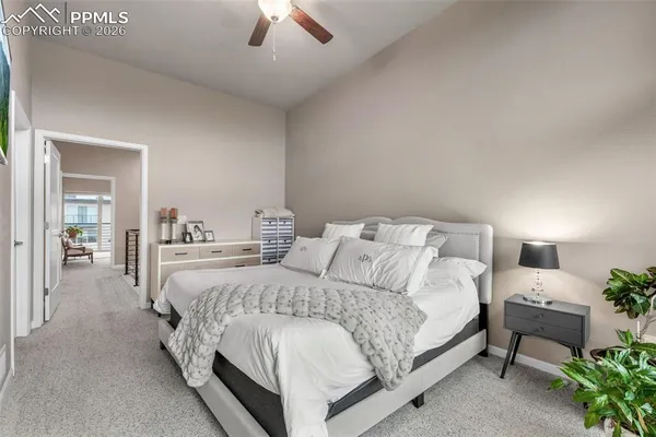 a spacious bedroom with a bed and a flat screen tv
