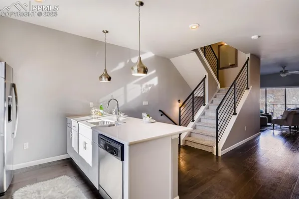 a living room with furniture and kitchen view