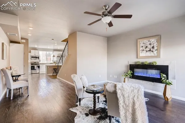 a living room with furniture and a potted plant