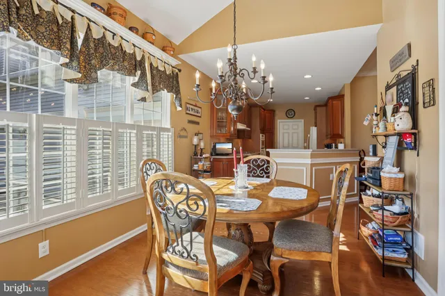 a view of a dining room with furniture and chandelier