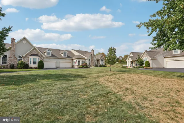 a view of green field with house in the background