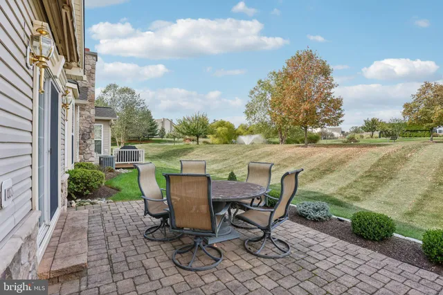 a view of a patio with a table and chairs