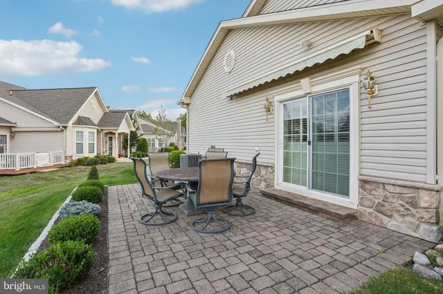 a view of a patio with table and chairs and potted plants