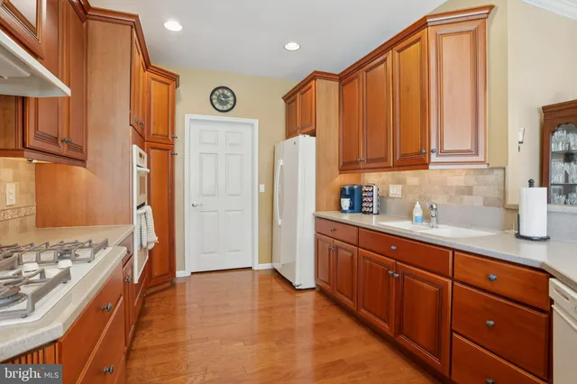 a kitchen with stainless steel appliances granite countertop a refrigerator and a sink
