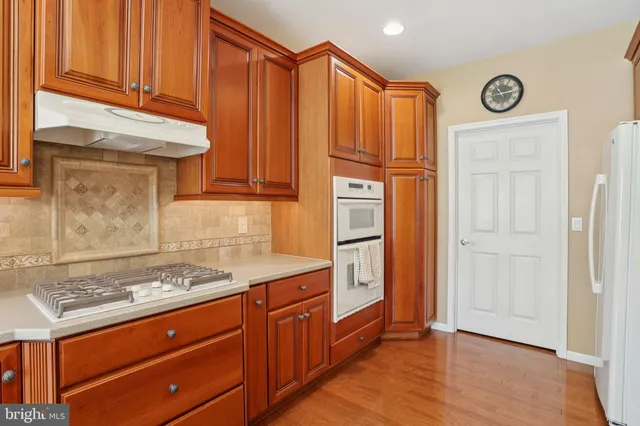 a kitchen with granite countertop cabinets and appliances