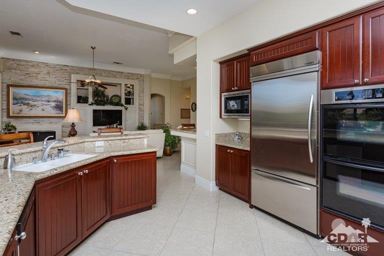 265 Loch Lomond Road Rancho Mirage, CA 92270 - Photo 11 of 46 a kitchen with stainless steel appliances granite countertop a refrigerator and a stove