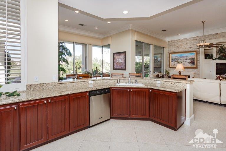 265 Loch Lomond Road Rancho Mirage, CA 92270 - Photo 12 of 46 a large kitchen with stainless steel appliances granite countertop a sink and cabinets