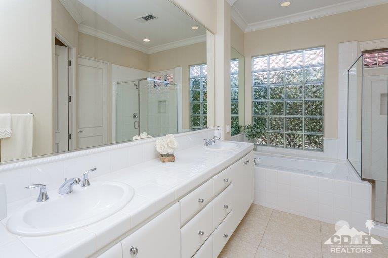 265 Loch Lomond Road Rancho Mirage, CA 92270 - Photo 18 of 46 a bathroom with double vanity sinks a large mirror and a shower