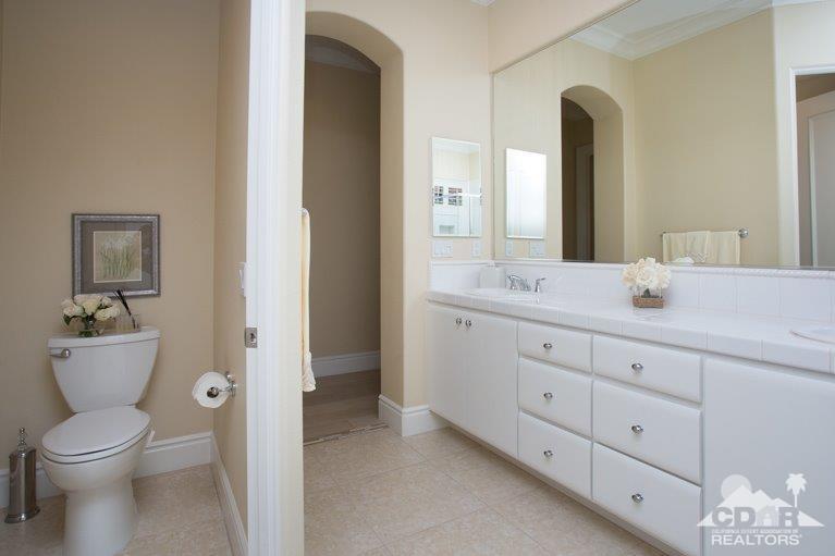 265 Loch Lomond Road Rancho Mirage, CA 92270 - Photo 20 of 46 a bathroom with a toilet a sink and mirror