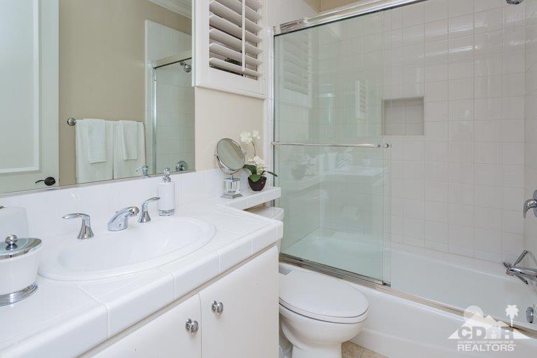 265 Loch Lomond Road Rancho Mirage, CA 92270 - Photo 23 of 46 a bathroom with a sink a toilet and a large mirror