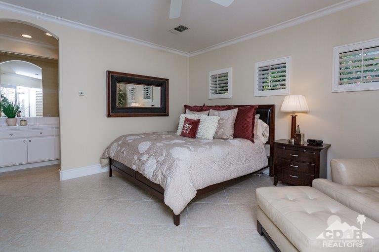265 Loch Lomond Road Rancho Mirage, CA 92270 - Photo 27 of 46 a bedroom with a bed and a chandelier
