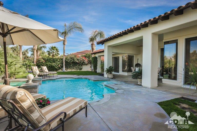265 Loch Lomond Road Rancho Mirage, CA 92270 - Photo 32 of 46 a view of a patio with couches table and chairs under an umbrella