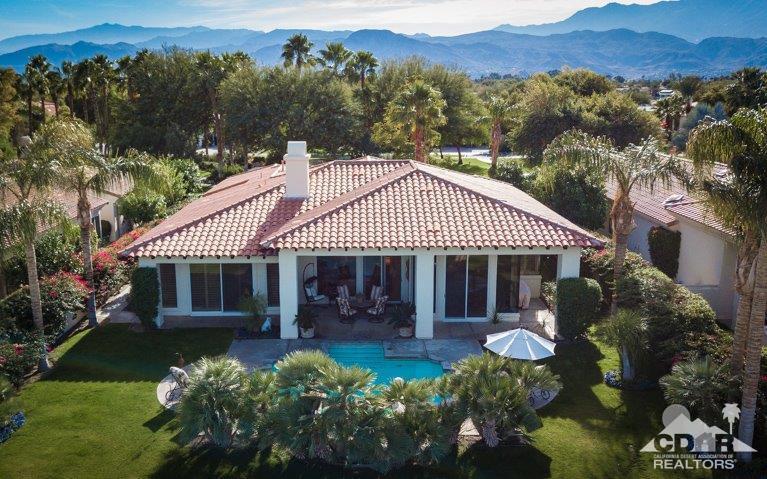 265 Loch Lomond Road Rancho Mirage, CA 92270 - Photo 39 of 46 a front view of a house with a garden and swimming pool