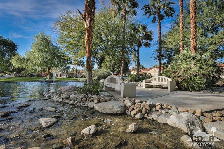 265 Loch Lomond Road Rancho Mirage, CA 92270 - Photo 44 of 46 a view of a backyard with fountain plants and large tree