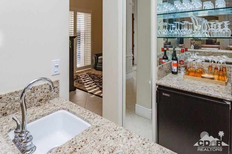 265 Loch Lomond Road Rancho Mirage, CA 92270 - Photo 8 of 46 a bathroom with a granite countertop sink and a mirror