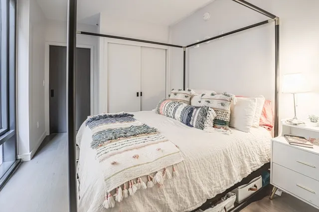 a bedroom with a bed and a window