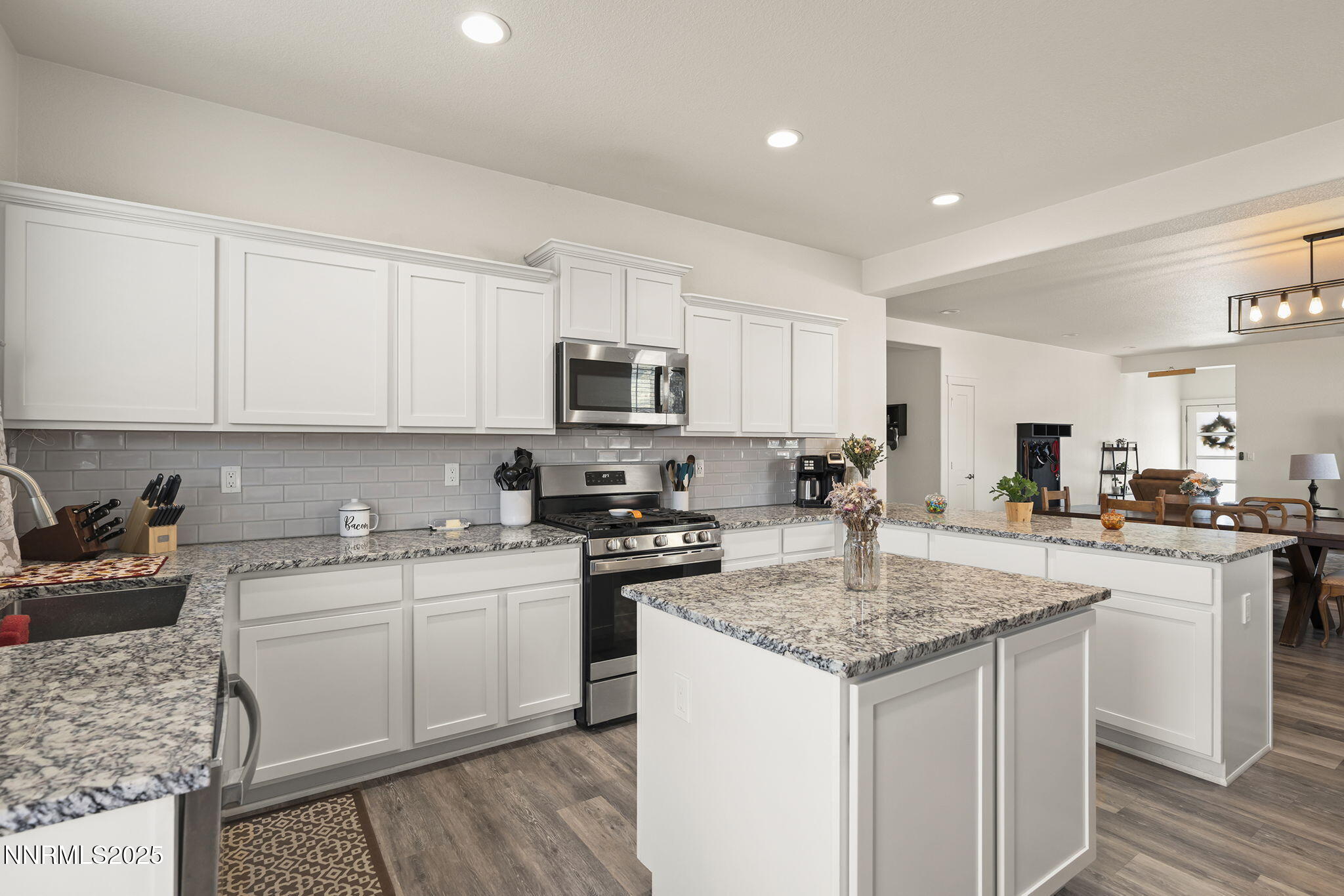19064 Bronco Crk Court Reno, NV 89508 - Photo 11 of 20 a kitchen with stainless steel appliances granite countertop a sink stove and cabinets