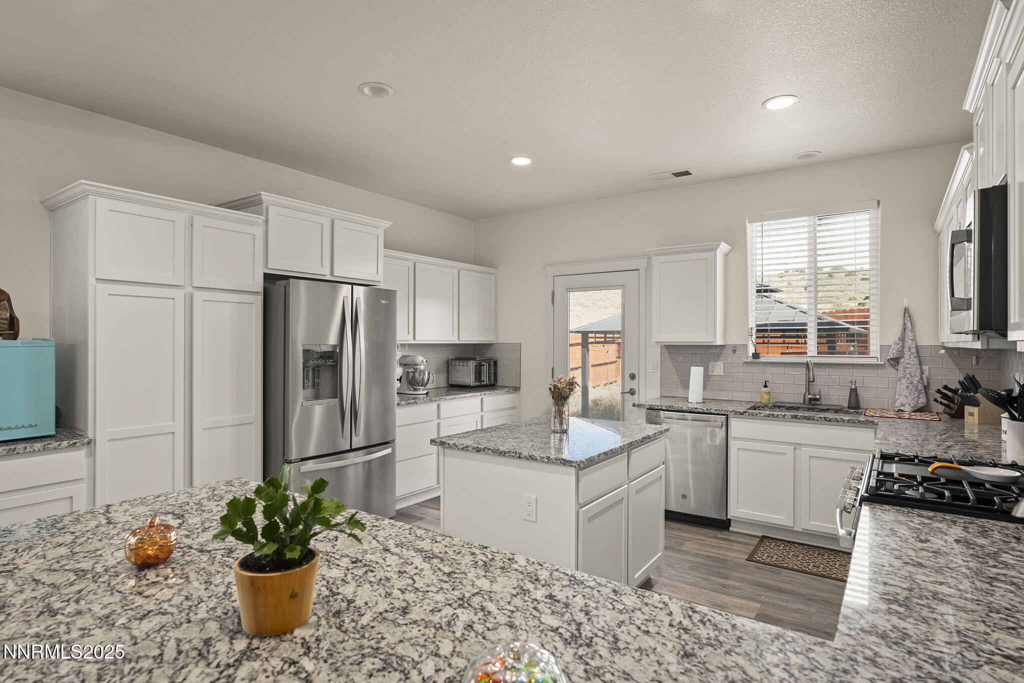 19064 Bronco Crk Court Reno, NV 89508 - Photo 9 of 20 a kitchen with a sink stainless steel appliances and cabinets