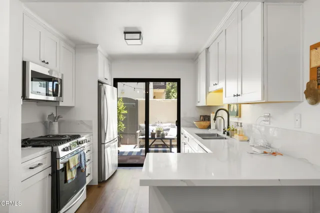 a kitchen with a sink a stove and cabinets