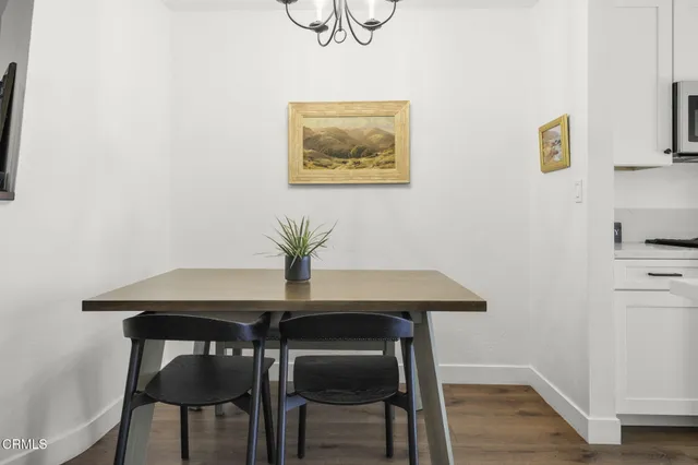 a view of a dining room with furniture and wooden floor
