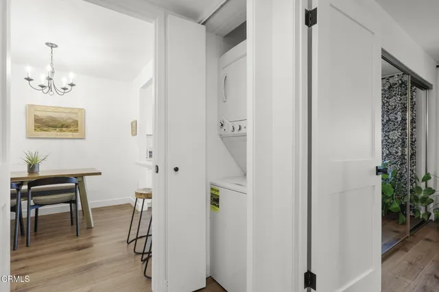 a view of a hallway with furniture and wooden floor