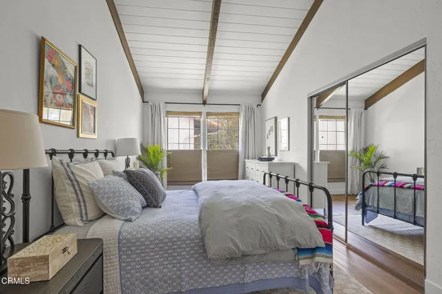 a spacious bedroom with a bed and large windows