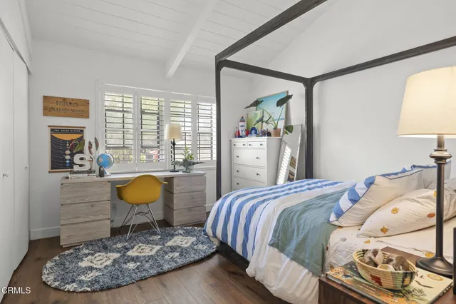 a bed room with a bed and a painting on the wall