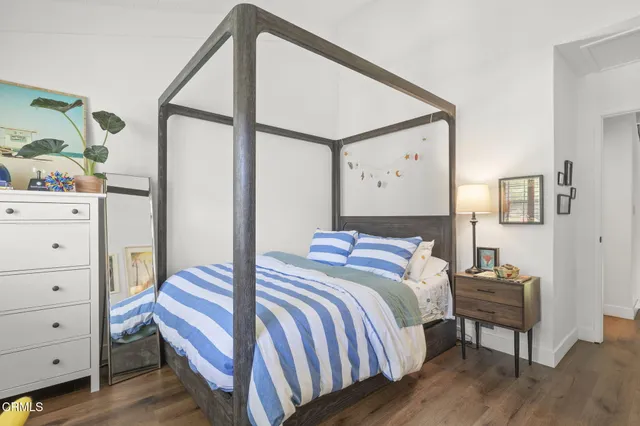 a bedroom with a bed and a dresser