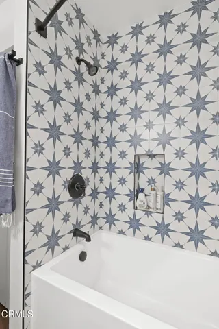a bathroom with a bathtub and shower