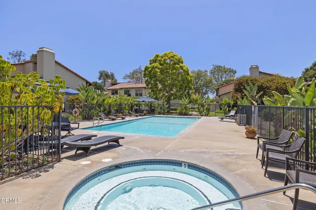 a swimming pool with outdoor seating and yard