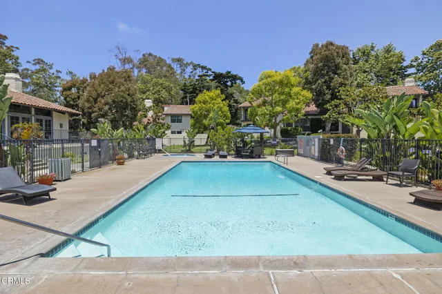a view of a tennis ground with large trees