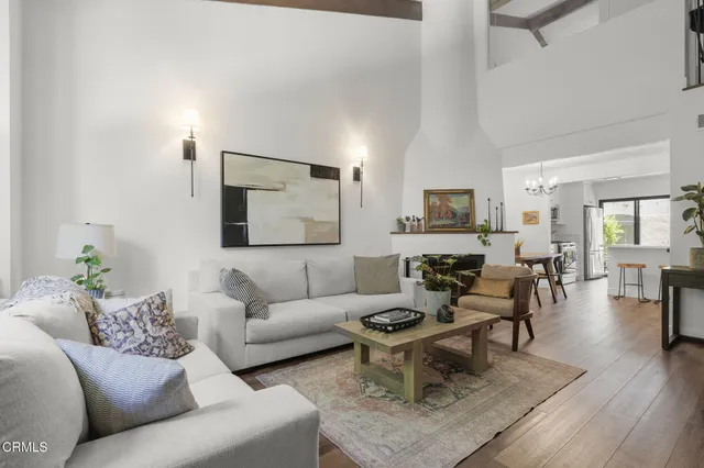a living room with fireplace furniture and a wooden floor