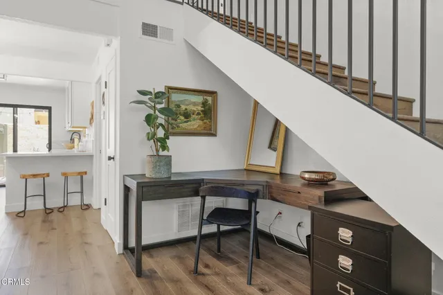a view of entryway and hall with wooden floor