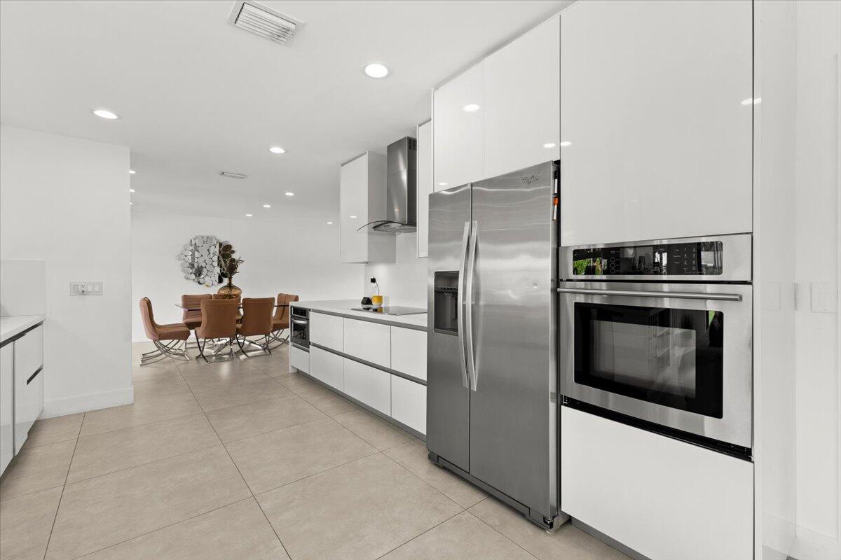 1049 West Palmetto Park Road Boca Raton, FL 33486 - Photo 12 of 40 a kitchen with stainless steel appliances a stove a sink and a refrigerator
