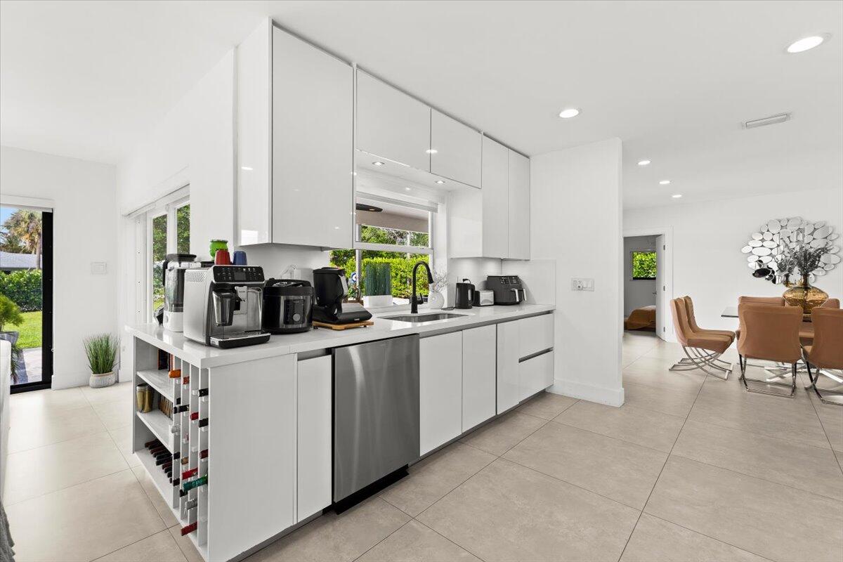 1049 West Palmetto Park Road Boca Raton, FL 33486 - Photo 13 of 40 a kitchen filled with white cabinets and white appliances