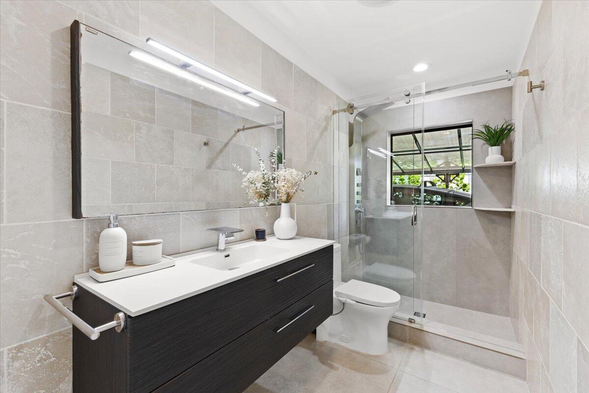 1049 West Palmetto Park Road Boca Raton, FL 33486 - Photo 23 of 40 a bathroom with a sink toilet and shower